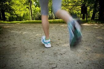 a person walking in a park with a skateboard at Binford Lofts Apartments, Los Angeles , CA